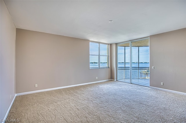 empty room featuring carpet and a water view