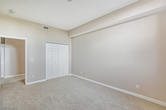 unfurnished bedroom with a closet and carpet