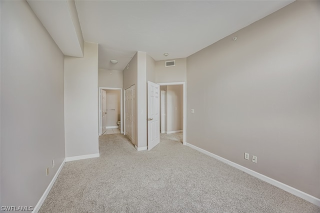 empty room featuring light colored carpet