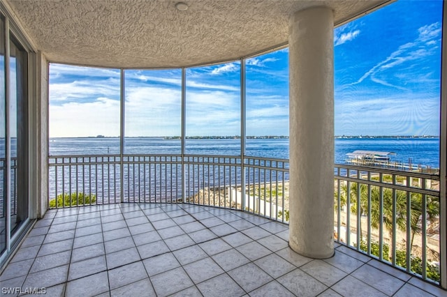 unfurnished sunroom with a water view