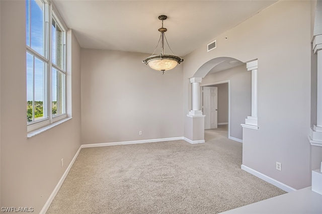 carpeted empty room with ornate columns