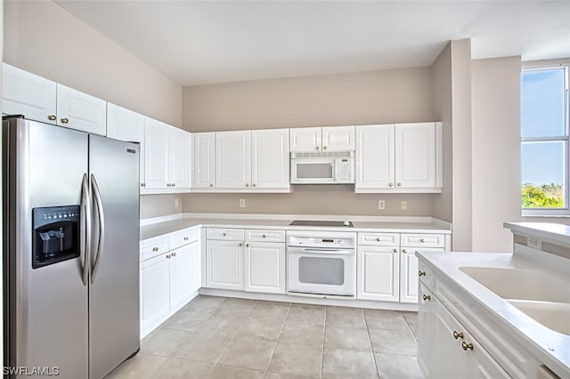 kitchen featuring white cabinetry, sink, and white appliances