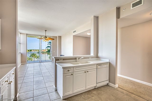 kitchen featuring ceiling fan, dishwasher, pendant lighting, sink, and white cabinetry