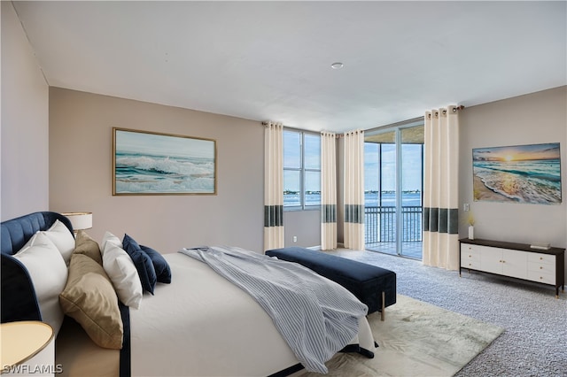 bedroom featuring floor to ceiling windows, access to outside, and carpet flooring