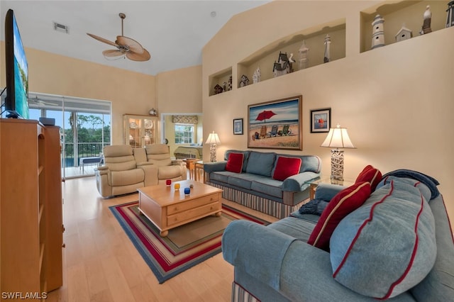 living room featuring ceiling fan and light hardwood / wood-style floors