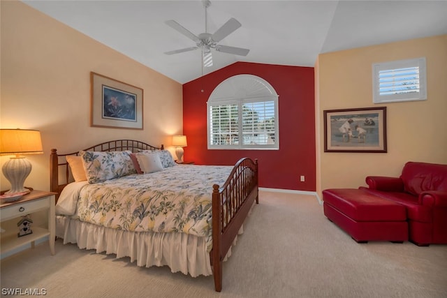 carpeted bedroom with ceiling fan, multiple windows, and vaulted ceiling