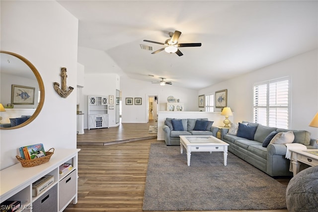 living room with vaulted ceiling, dark hardwood / wood-style floors, and ceiling fan