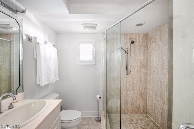 bathroom with vanity, a shower with shower door, toilet, and tile patterned flooring
