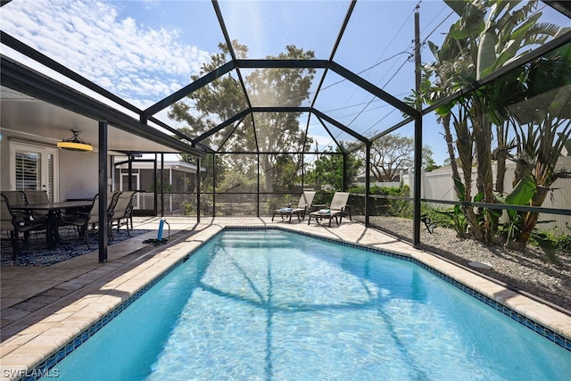 view of pool with a lanai, ceiling fan, and a patio area