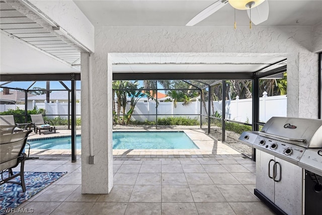view of pool featuring ceiling fan, grilling area, glass enclosure, and a patio area
