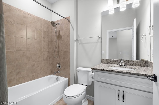 full bathroom with toilet, vanity, and tiled shower / bath