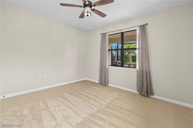 empty room with light colored carpet and ceiling fan