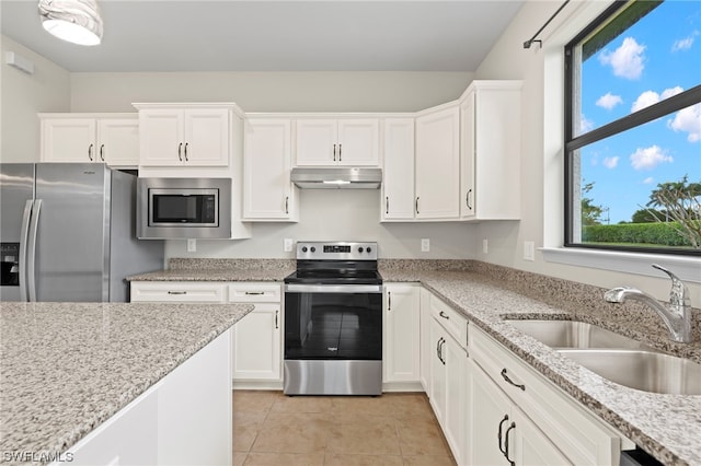 kitchen with light stone countertops, white cabinetry, sink, and appliances with stainless steel finishes