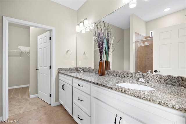 bathroom featuring tile patterned floors, vanity, and walk in shower