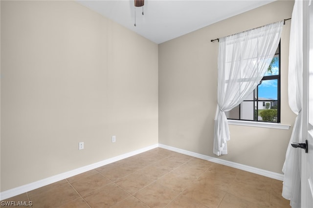 empty room featuring ceiling fan and light tile patterned floors