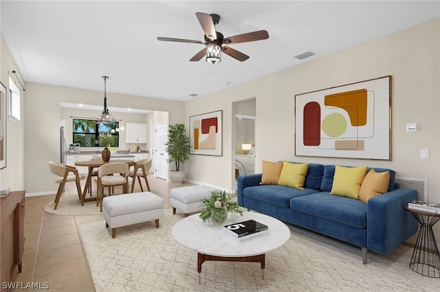 tiled living room featuring ceiling fan