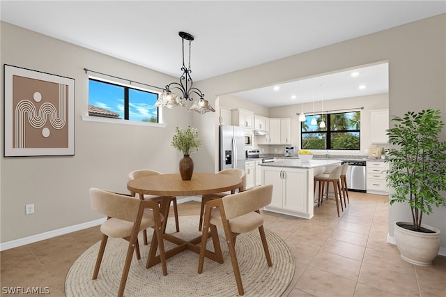 tiled dining area with a notable chandelier