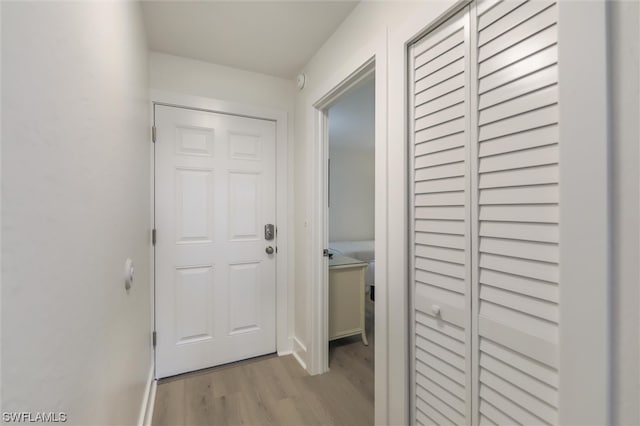 corridor with light hardwood / wood-style flooring