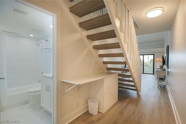 stairway featuring hardwood / wood-style floors