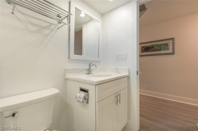 bathroom featuring hardwood / wood-style flooring, vanity, and toilet