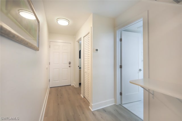 corridor with light hardwood / wood-style flooring