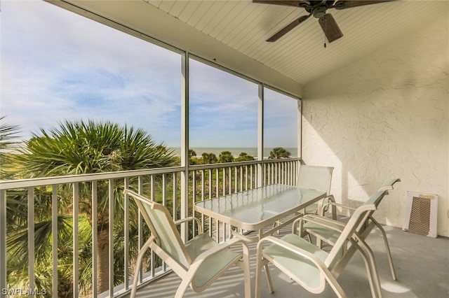 sunroom / solarium with vaulted ceiling, ceiling fan, and plenty of natural light