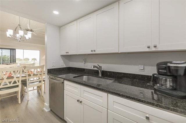 kitchen featuring white cabinetry, light hardwood / wood-style flooring, stainless steel dishwasher, sink, and a chandelier