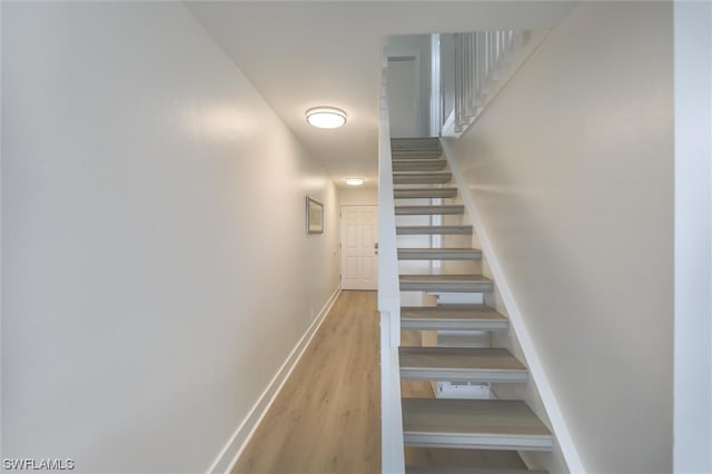 stairs featuring wood-type flooring