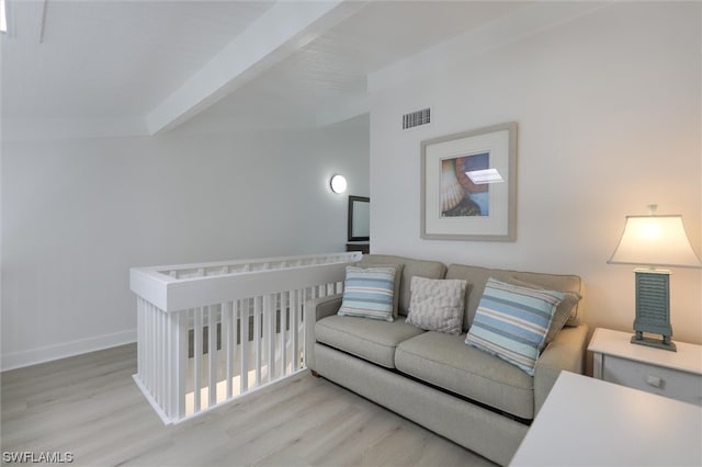 living room with beamed ceiling and light hardwood / wood-style floors