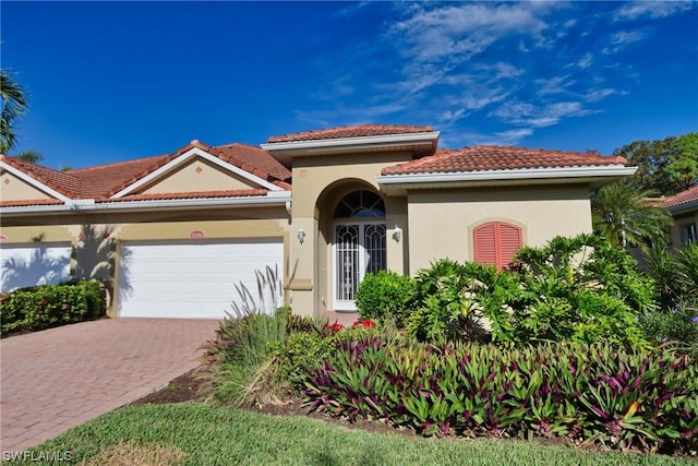 mediterranean / spanish-style home with a garage