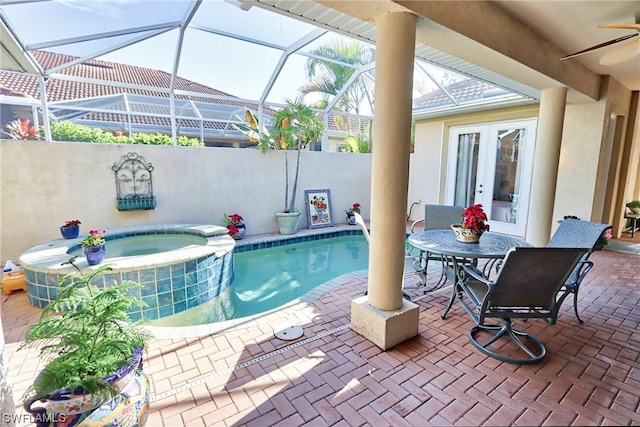 view of swimming pool featuring an in ground hot tub, a patio area, and french doors