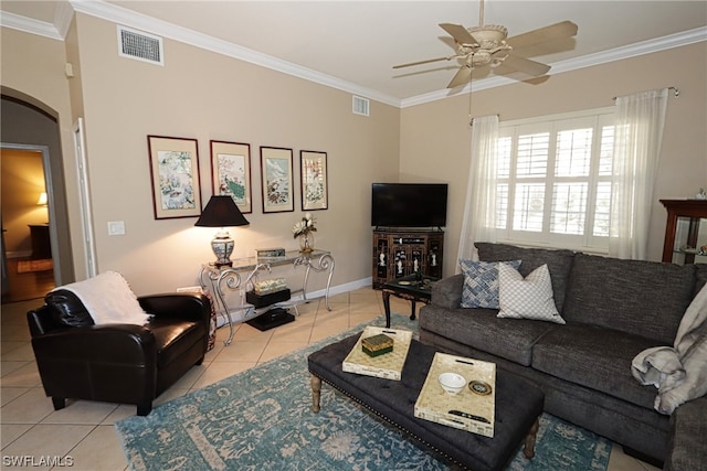 tiled living room featuring ceiling fan and crown molding