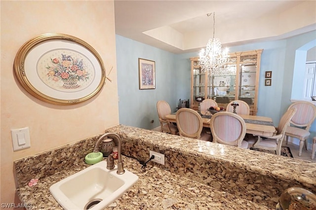 5526 Cheshire Dr, Fort Myers, FL 33912 - bathroom featuring sink, an inviting chandelier, and a tray ceiling