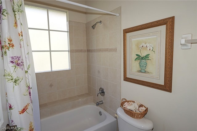 bathroom with toilet, a healthy amount of sunlight, and shower / bath combination with curtain