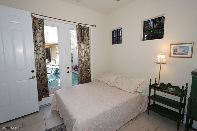 bedroom featuring light tile patterned floors, french doors, and access to exterior