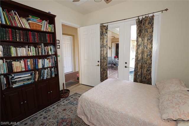 bedroom with access to outside, french doors, multiple windows, and light tile patterned floors