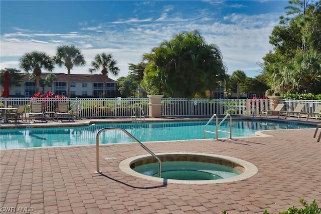 view of swimming pool featuring a patio area and a community hot tub