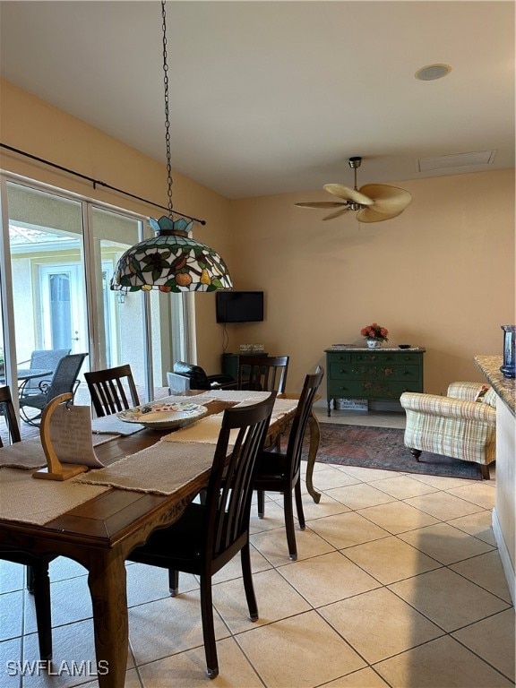 tiled dining room featuring ceiling fan