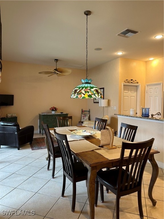 dining area featuring light tile patterned floors and ceiling fan