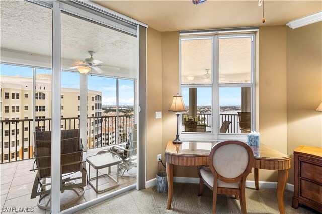 sunroom / solarium featuring a healthy amount of sunlight and ceiling fan