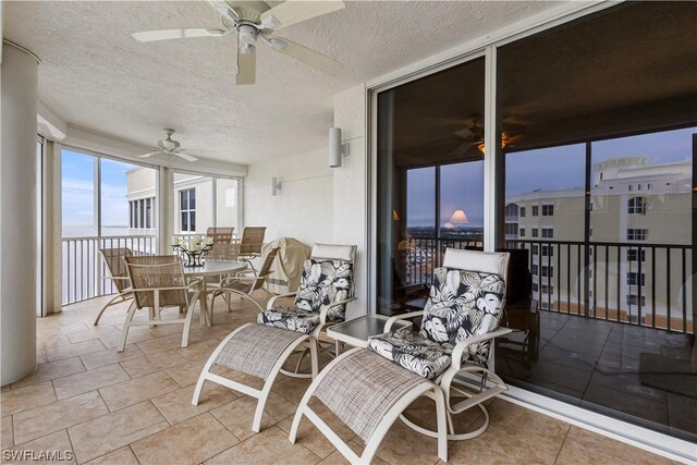 sunroom featuring ceiling fan