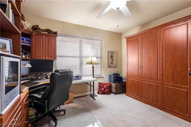 carpeted home office with ceiling fan