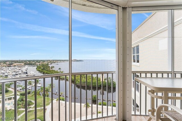 unfurnished sunroom featuring a wealth of natural light and a water view