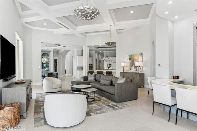 living room featuring coffered ceiling, crown molding, light tile patterned floors, a towering ceiling, and beamed ceiling