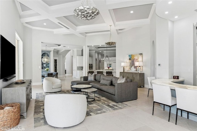 tiled living area featuring coffered ceiling, an inviting chandelier, recessed lighting, arched walkways, and a towering ceiling