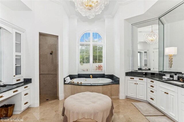 bathroom with crown molding, vanity, shower with separate bathtub, and an inviting chandelier