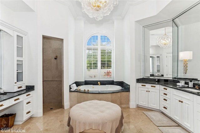 full bath featuring a notable chandelier, vanity, crown molding, and walk in shower