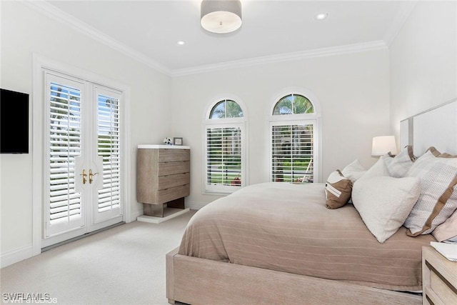 bedroom featuring access to exterior, ornamental molding, multiple windows, and carpet floors