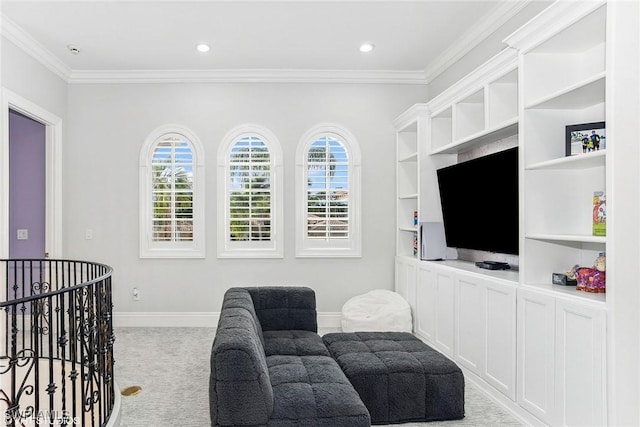 living area featuring baseboards, a healthy amount of sunlight, and ornamental molding