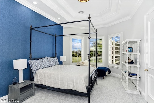 carpeted bedroom featuring visible vents, baseboards, a tray ceiling, and ornamental molding